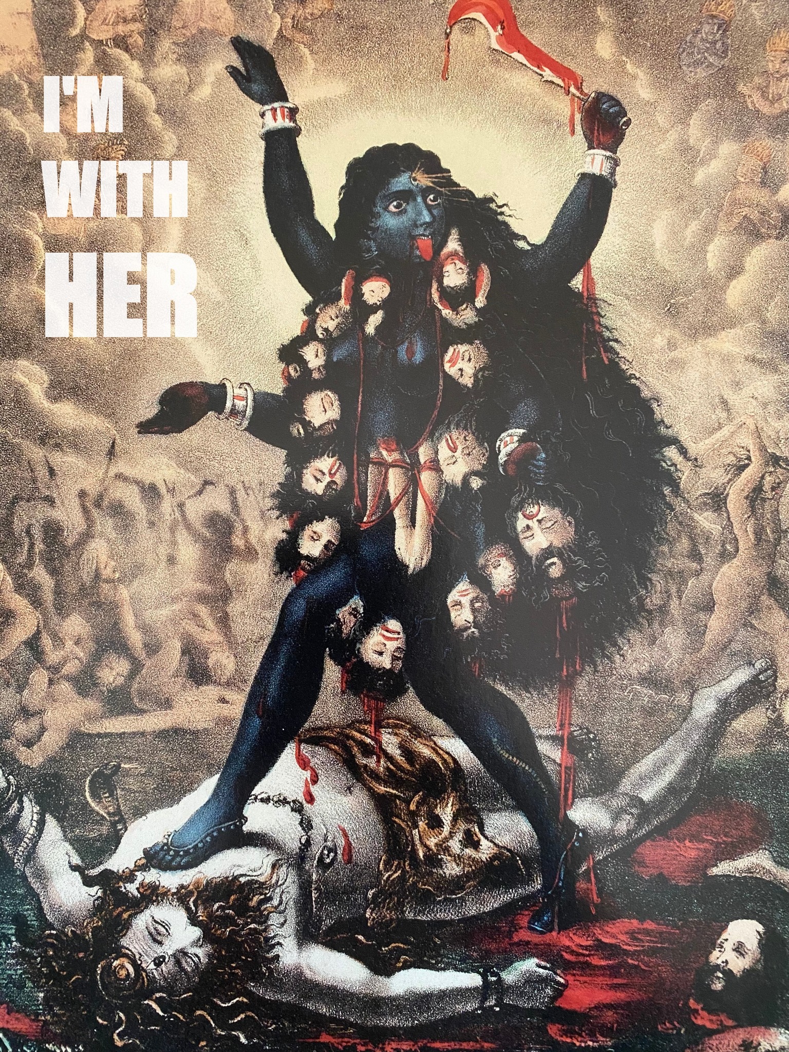 The meme features a image of the Hindu goddess Kali, a fierce and powerful deity, standing on top of a man who is being devoured by snakes and demons. The text "I'm with her" appears in the top left corner of the image, a play on the 2016 US presidential campaign slogan "I'm with her" used by Hillary Clinton's supporters. The meme is a humorous and irreverent take on the goddess Kali, juxtaposing her fierce and powerful image with a lighthearted and playful reference to the 2016 election.